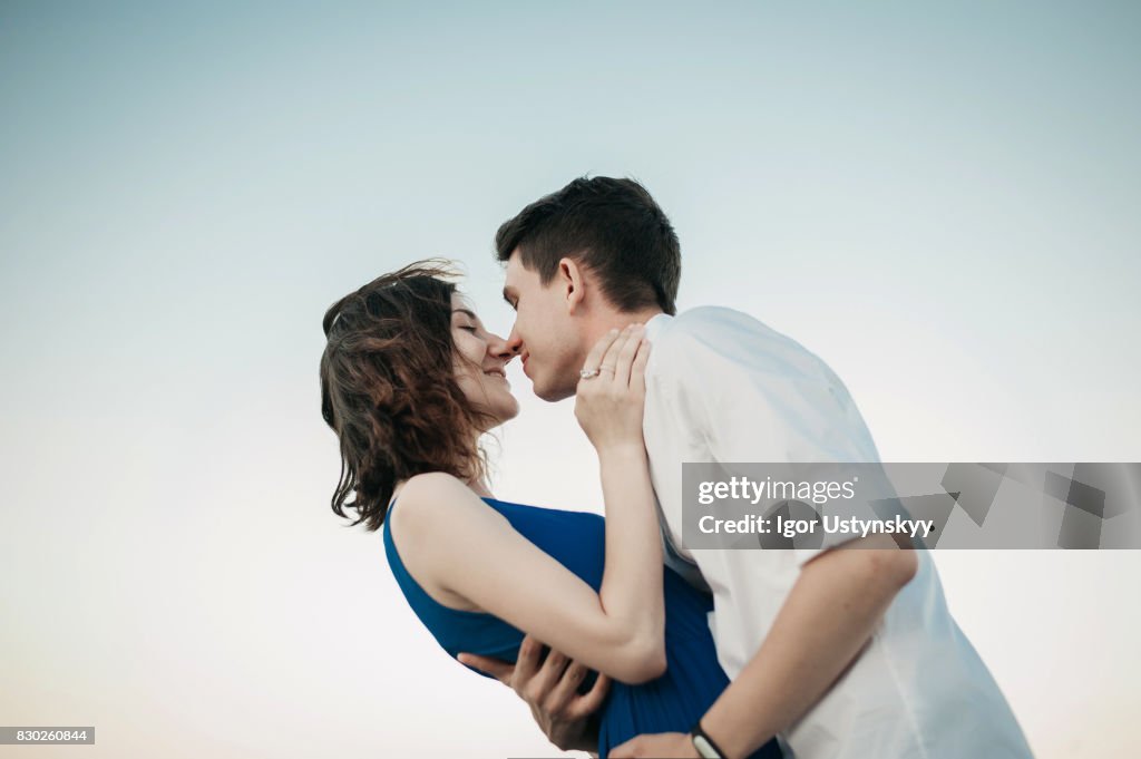 Couple kissing near the sea