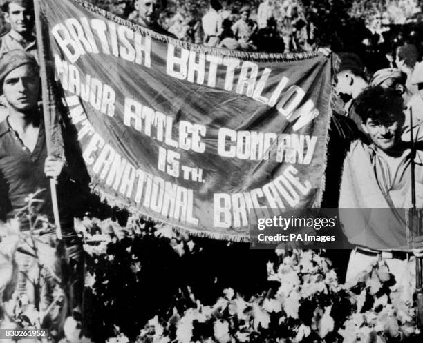 Members of the British Battalion, Major Attlee Company, 15th International Brigade, displaying their banner during a lull in the fighting during the...