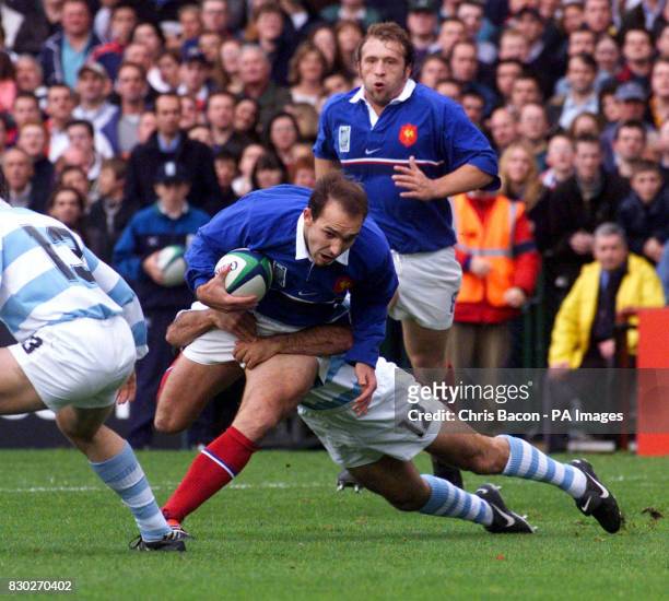 France's Marc Lievremont is brought down by Argentina's Lisandro Arbizu , during their Rugby World Cup Quarter Final match at Lansdowne Road in...