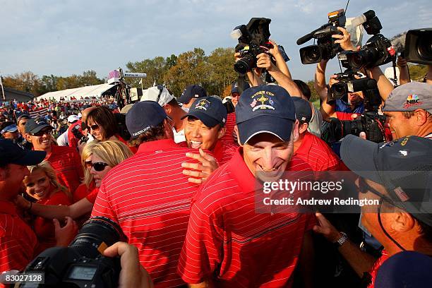 Anthony Kim and Jim Furyk of the USA team celebrate among teammates and media in honor of the USA 16 1/2 - 11 1/2 victory on the final day of the...