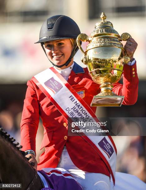 Dublin , Ireland - 11 August 2017; Lillie Keenan of USA lifts the Aga Khan Trophy after winning the FEI Nations Cup during the Dublin International...