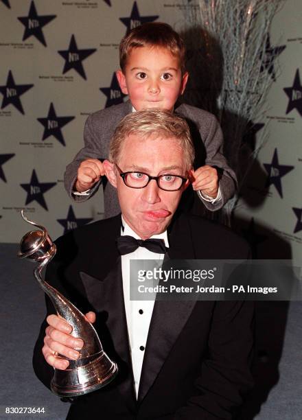 Child actor Scott Chisholm pulls the ears of Paul O'Grady, aka Lily Savage, at the National Television Awards at the Royal Albert Hall, in London.