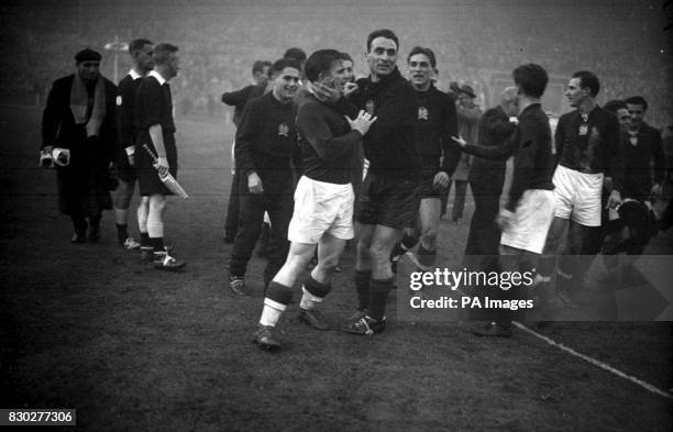 Hungarian goalkeeper Sandor Geller embraces his captain, inside-left Ferenc Puskas after Hungary had defeated England 6-3 in the International match...