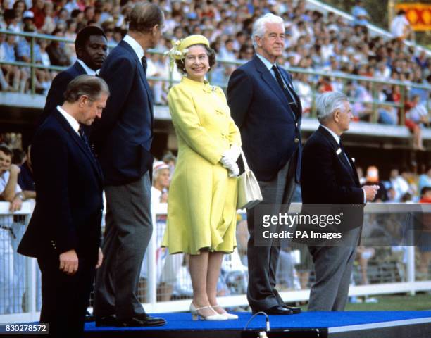 Queen Elizabeth II, flanked left by the Duke of Edinburgh and right by Sir Alexander Ross, Chairman of the Commonwealth Games Foundation, at the...