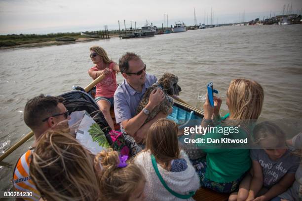 Holiday makers take the ferry to Southwold, which consists of a traditional rowing boat that has been run since 1885 by the same family for five...