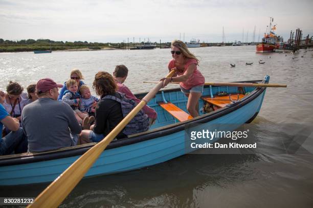 Holiday makers take the ferry to Southwold, which consists of a traditional rowing boat that has been run since 1885 by the same family for five...