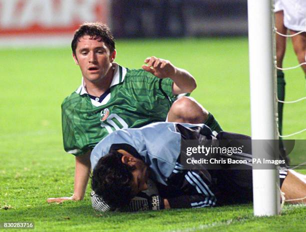 Turkey's goalkeeper Rustu Recber, beats Republic of Ireland's Robert Keane to the ball during the1st Leg of their Euro 2000 football match at...