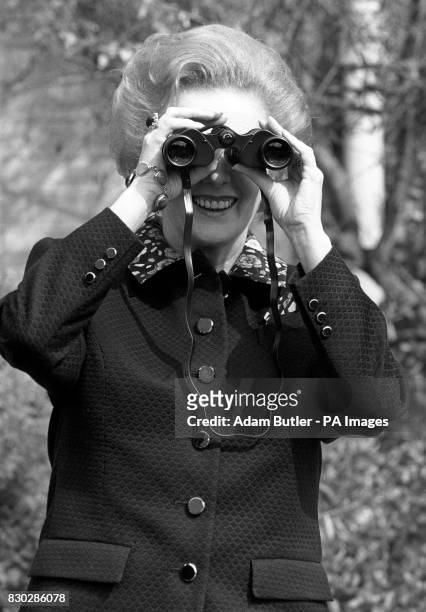 Prime Minister Margaret Thatcher trains her binoculars on the camera during a visit to the Royal Society for the Protection of Birds headquarters in...
