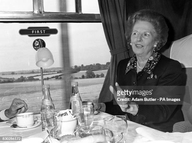 Prime Minister Margaret Thatcher making her first train journey since the general election to Bedfordshire to visit the headquarters of the Royal...