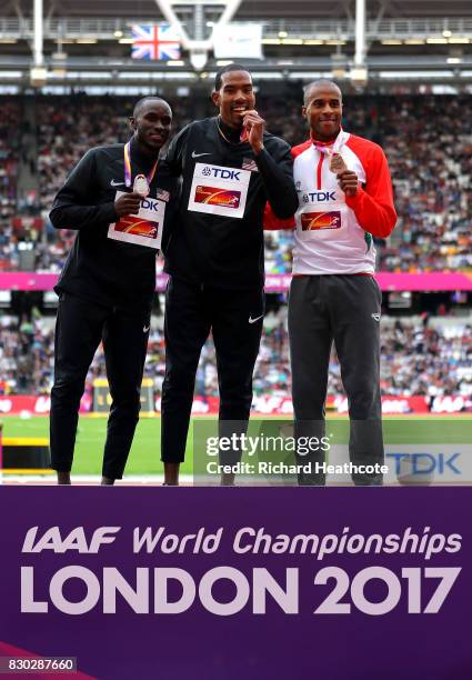 Will Claye of the United States, silver, Christian Taylor of the United States, gold, and Nelson Evora of Portugal, bronze, pose with their medals...