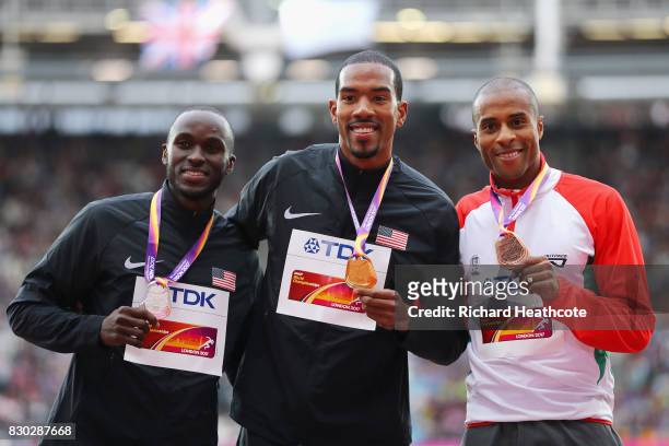 Will Claye of the United States, silver, Christian Taylor of the United States, gold, and Nelson Evora of Portugal, bronze, pose with their medals...