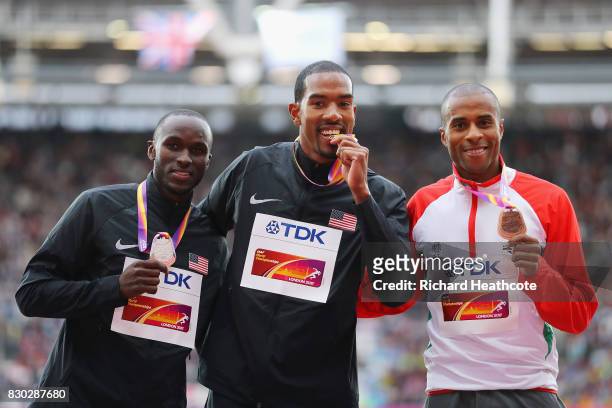 Will Claye of the United States, silver, Christian Taylor of the United States, gold, and Nelson Evora of Portugal, bronze, pose with their medals...