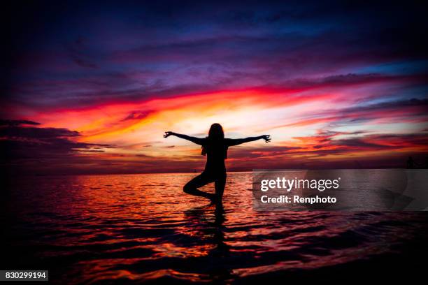 yoga at zen beach - new age stock pictures, royalty-free photos & images