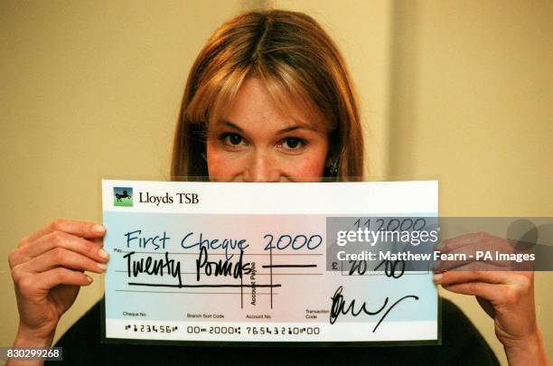 Supermodel Elle Macpherson shows her support for First Cheque 2000 by signing a giant cheque in favour of the charity at the Halcyon Hotel in London....