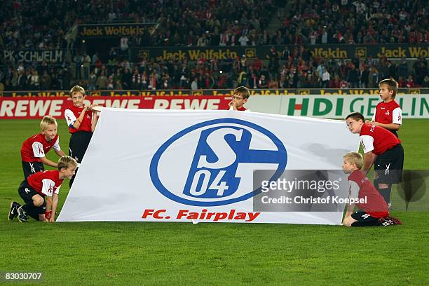 Ballboys show a banner during the Bundesliga match between 1. FC Koeln and FC Schalke 04 at the RheinEnergie stadium on September 26, 2008 in...