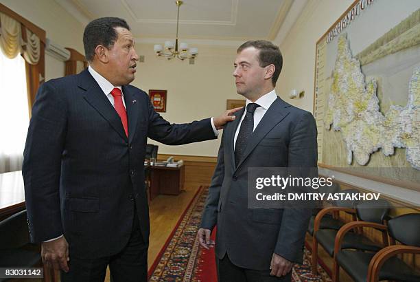 Russian President Dmitry Medvedev speaks with his Venezuelan counterpart Hugo Chavez during their meeting in Orenburg on September 26, 2008....