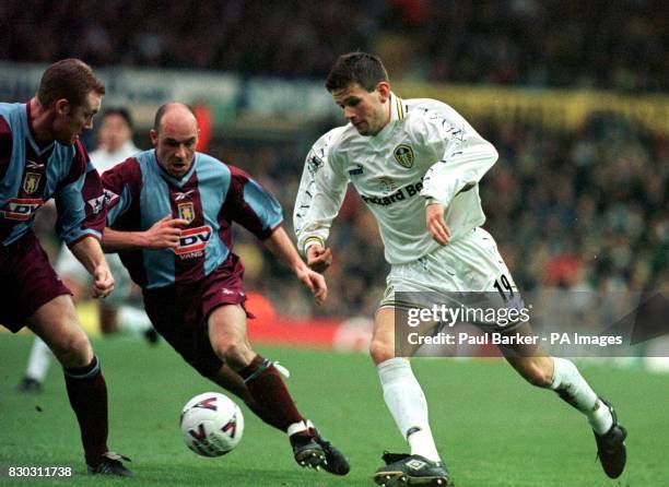 This picture can only be used within the context of an editorial feature. Leeds United's Eirik Bakke moves past Aston Villa player's Steve Watson and...