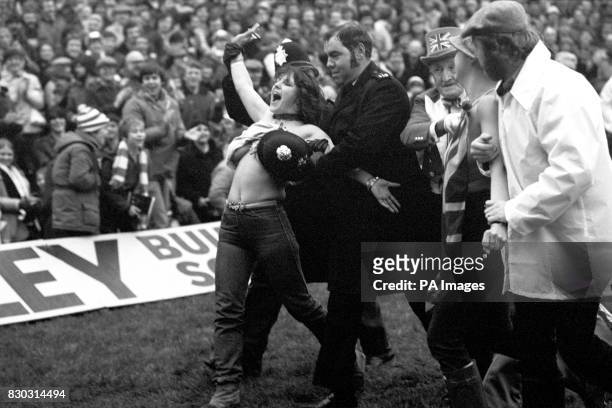 Topless streaker Erica Roe is covered up by police, during a rugby international match between England and Australia at Twickenham.