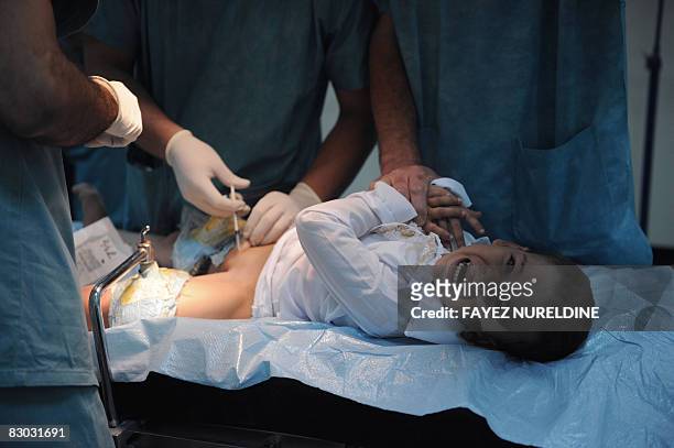 An Algerian boy screams before being circumcised during a mass circumcision at a local hospital September 27, 2008. In Algiers. The Muslim religion...