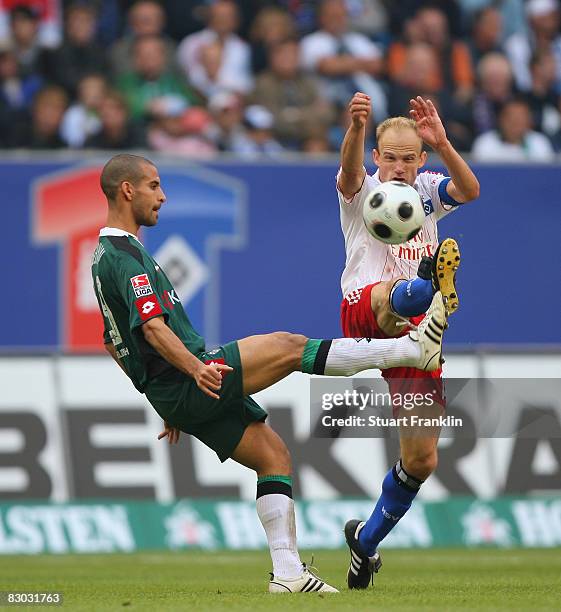 David Jarolim of Hamburg challenges with Gal Alberman of Gladbach during the Bundesliga match between Hamburger SV and Borussia M'gladbach at the HSH...