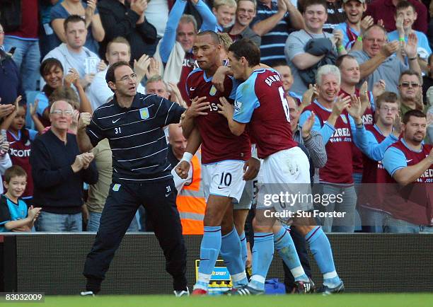 Aston Villa manager Martin O'Neill celebrates with John Carew, scorer of the 2nd Villa goal during the Barclays Premier League match between Aston...