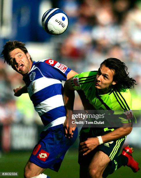 Akos Buzsaky of Queens Park Rangers and Nacer Barazite of Derby County fight for the ball during the Coca Cola Championship match between Queens Park...