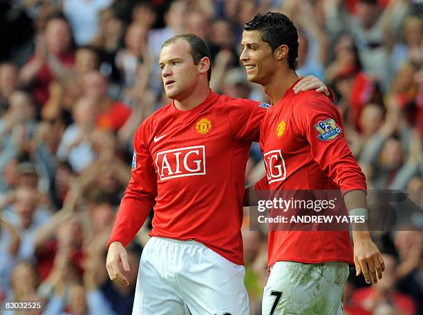 Manchester United's English forward Wayne Rooney celebrates after scoring with Manchester United's Portugese midfielder Cristiano Ronaldo during the...