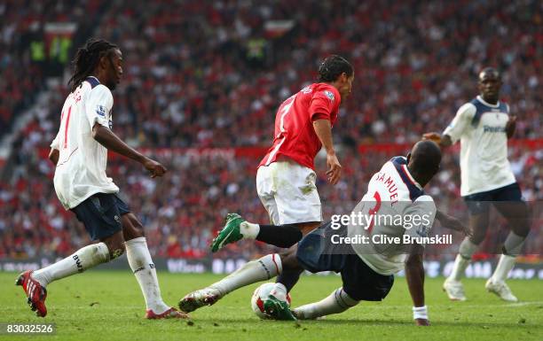 Jlloyd Samuel of Bolton Wanderers brings down Cristiano Ronaldo of Manchester United to concede a penalty kick during the Barclays Premier League...