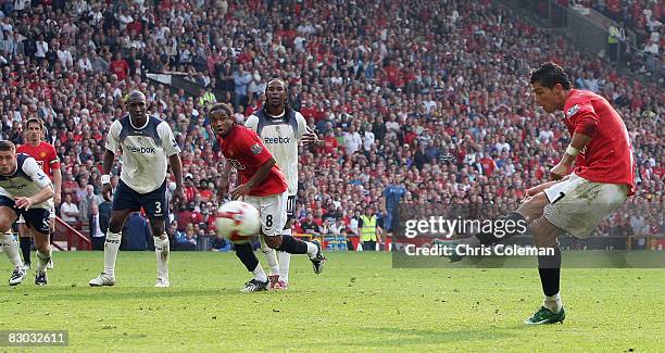 Cristiano Ronaldo of Manchester United scores their first goal during the FA Premier League match between Manchester United and Bolton Wanderers at...