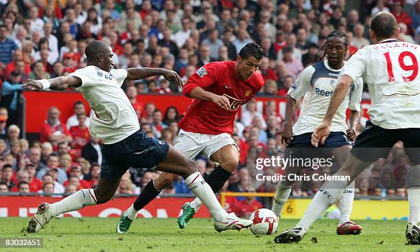 Cristiano Ronaldo of Manchester United clashes with Jlloyd Samuel which led to a penalty during the FA Premier League match between Manchester United...