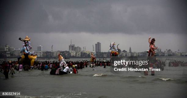 Ganpati Visarjan: Devotees carry a statue of Ganesh Idol , for immersion in the sea in Mumbai.