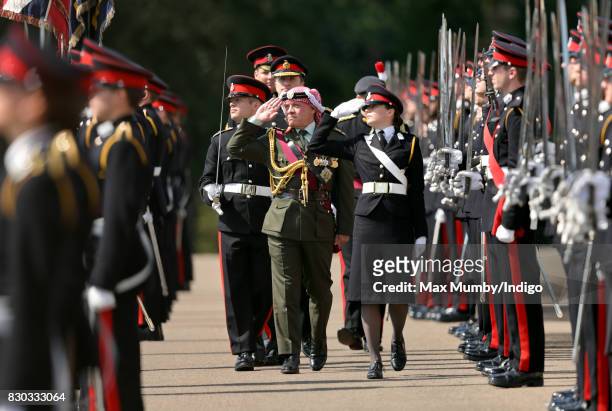 King Abdullah II of Jordan inspects the Officer Cadets as he represents Queen Elizabeth II during the Sovereign's Parade at the Royal Military...