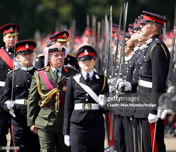 King Abdullah II of Jordan inspects the Officer Cadets as he represents Queen Elizabeth II during the Sovereign's Parade at the Royal Military...