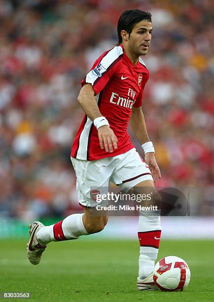 Cesc Fabregas of Arsenal runs with the ball during the Barclays Premier League match between Arsenal and Hull City at the Emirates Stadium on...