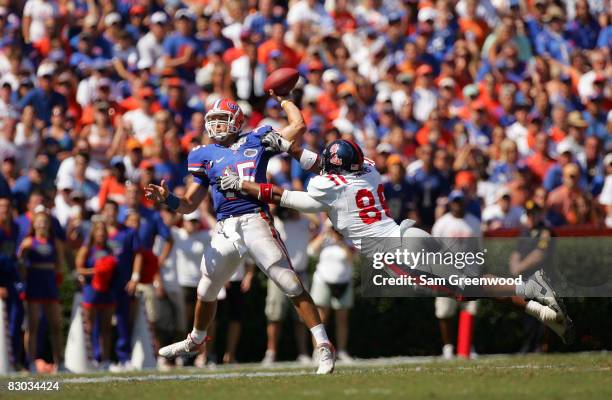 Quarterback Tim Tebow of the Florida Gators is pressured by Greg Hardy of the Ole Miss Rebels during the game at Ben Hill Griffin Stadium on...