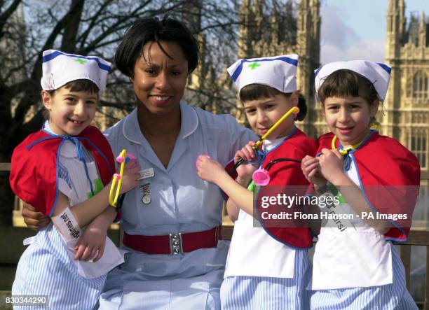 Paediatric Staff Nurse Pat Stanford with 7 year old triplets Gabrielle, Alexandra and Eleanor Grant, from St. Albans, outside St Thomas' Hospital,...