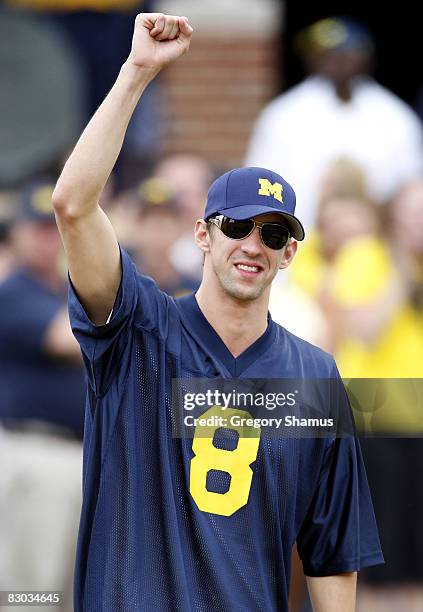 Olympic gold medal winner Michael Phelps is introduced prior to the game between the Wisconsin Badgers and the Michigan Wolverines on September 27,...