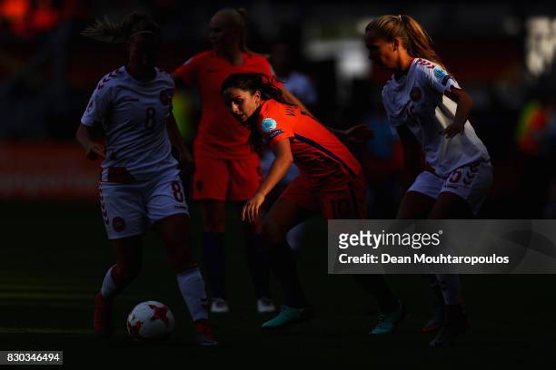 Danielle van de Donk of the Netherlands holds off pressure from Theresa Nielsen and Frederikke Thogersen of Denmark during the Final of the UEFA...