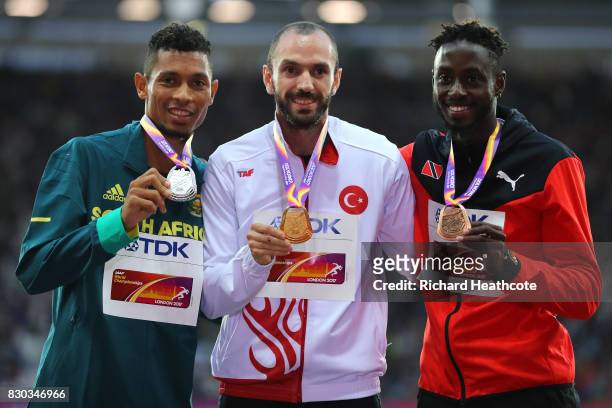 Wayde van Niekerk of South Africa, silver, Ramil Guliyev of Turkey, gold, and Jereem Richards of Trinidad and Tobago, bronze, pose with their medals...