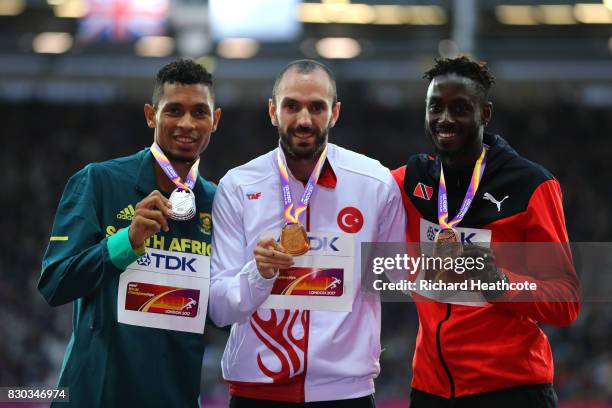 Wayde van Niekerk of South Africa, silver, Ramil Guliyev of Turkey, gold, and Jereem Richards of Trinidad and Tobago, bronze, pose with their medals...