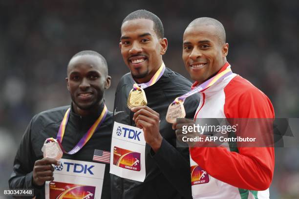 Silver medallist US athlete Will Claye , gold medallist US athlete Christian Taylor and bronze medallist Portugal's Nelson Evora pose on the podium...