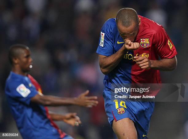 Thierry Henry of Barcelona reacts after scoring the equalizer backdropped by his teammate Samuel Eto'o during the La Liga match between Espanyol and...