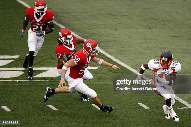 Wide receiver Jai Wilson of the Morgan State Bears is chased down on a punt return by cornerback Devin McCourty, linebacker Damaso Munoz and long...