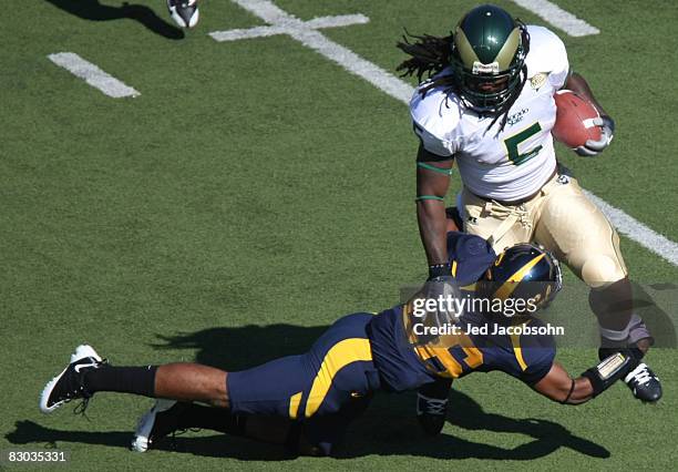 Gartrell Johnson of the Colorado State Rams is tackled by Darian Hagan of the California Golden Bears during an NCAA football game on September 27,...