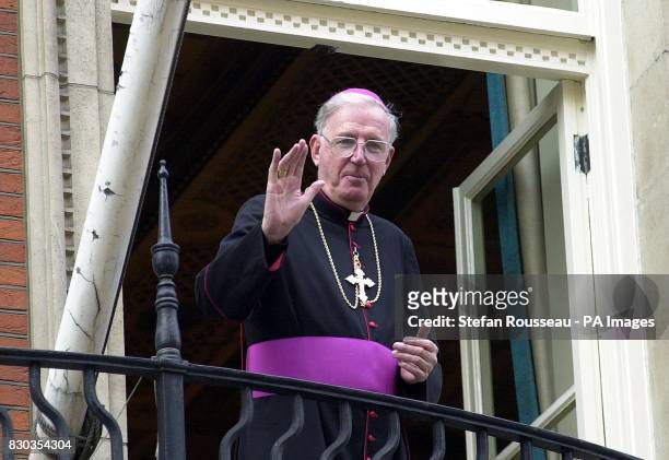 The new Archbishop of Westminster, the Most Rev Cormac Murphy-O'Connor, waves to well-wishers outside Westminster Cathedral in London, after his...