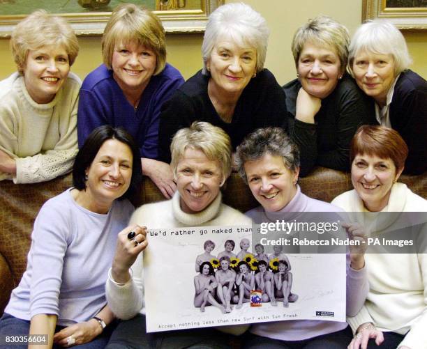 Members of the Rylestone Woman's Institute famous for their 'naked' calendar, together in London, with a copy of a new poster advertising a laundry...