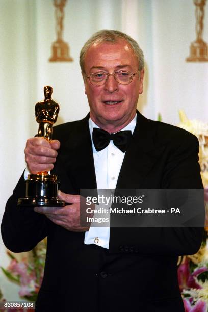 British actor, Michael Caine with his Oscar for Best Supporting Actor which he won for his role in the film The Cider House Rules, at the 72nd Annual...