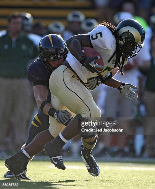 Gartrell Johnson of the Colorado State Rams is tackled by Eddie Young of the California Golden Bears during an NCAA football game on September 27,...