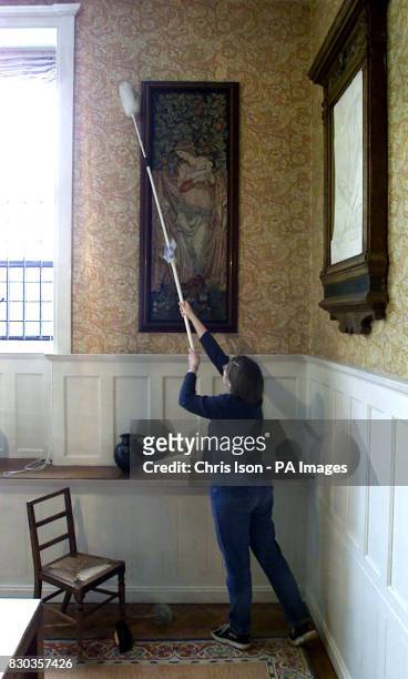 National Trust Conservation cleaner Emily Blanshard dusts a William Morris tapestry at Standen in Sussex. All National Trust properties will open for...