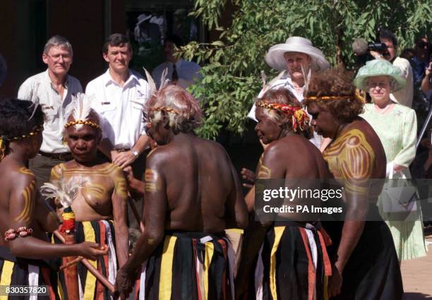 Queen Elizabeth II watches a group of Aborigine dancers during a visit to the Desert Wild Life Park in Alice Springs, Australia.